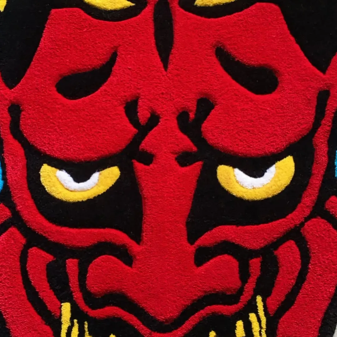 Handmade Emberheart Ink Rug inspired by Japanese mask art in vibrant red, yellow, and black tones