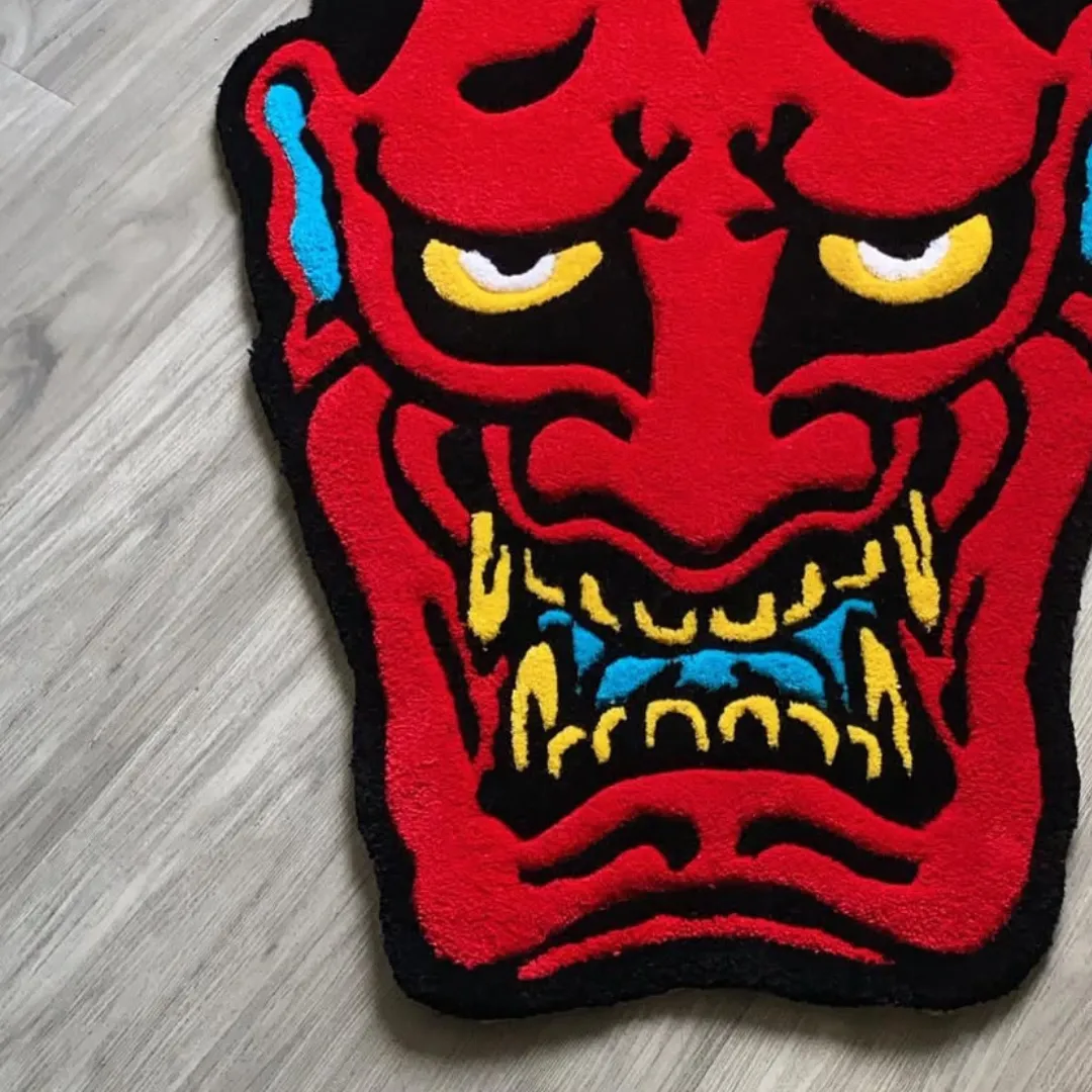 Emberheart Ink Rug featuring fierce red demon face with yellow horns and blue accents – handmade tufted rug by Sneagear